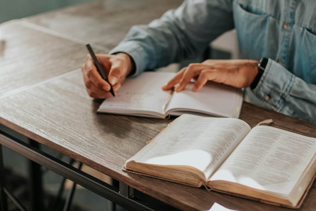 Person reading Bible and taking notes
